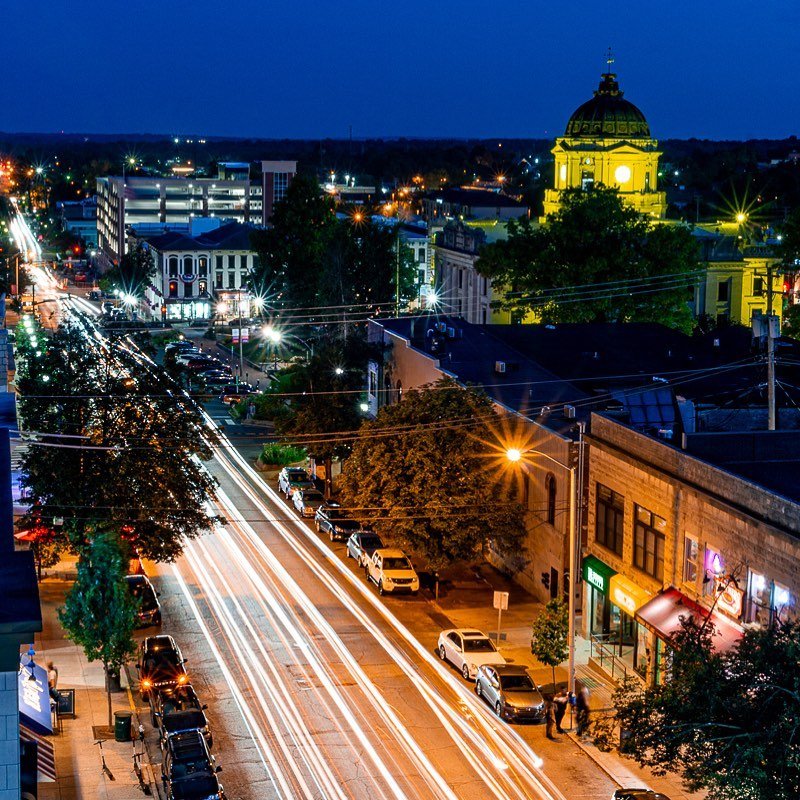 Downtown Bloomington at night, with the illuminated courthouse and light trails along the street.